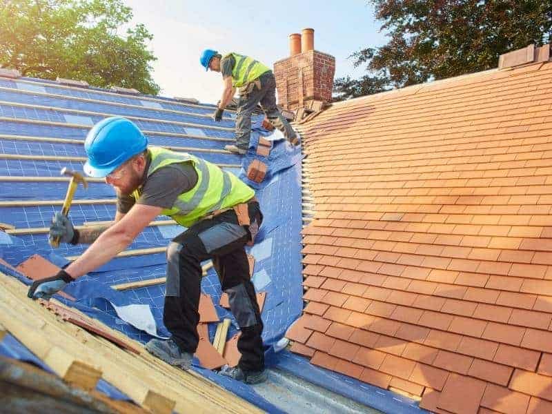 New Cedar color roof shingles being installed by local roofing crew from charlotte roofing contractor