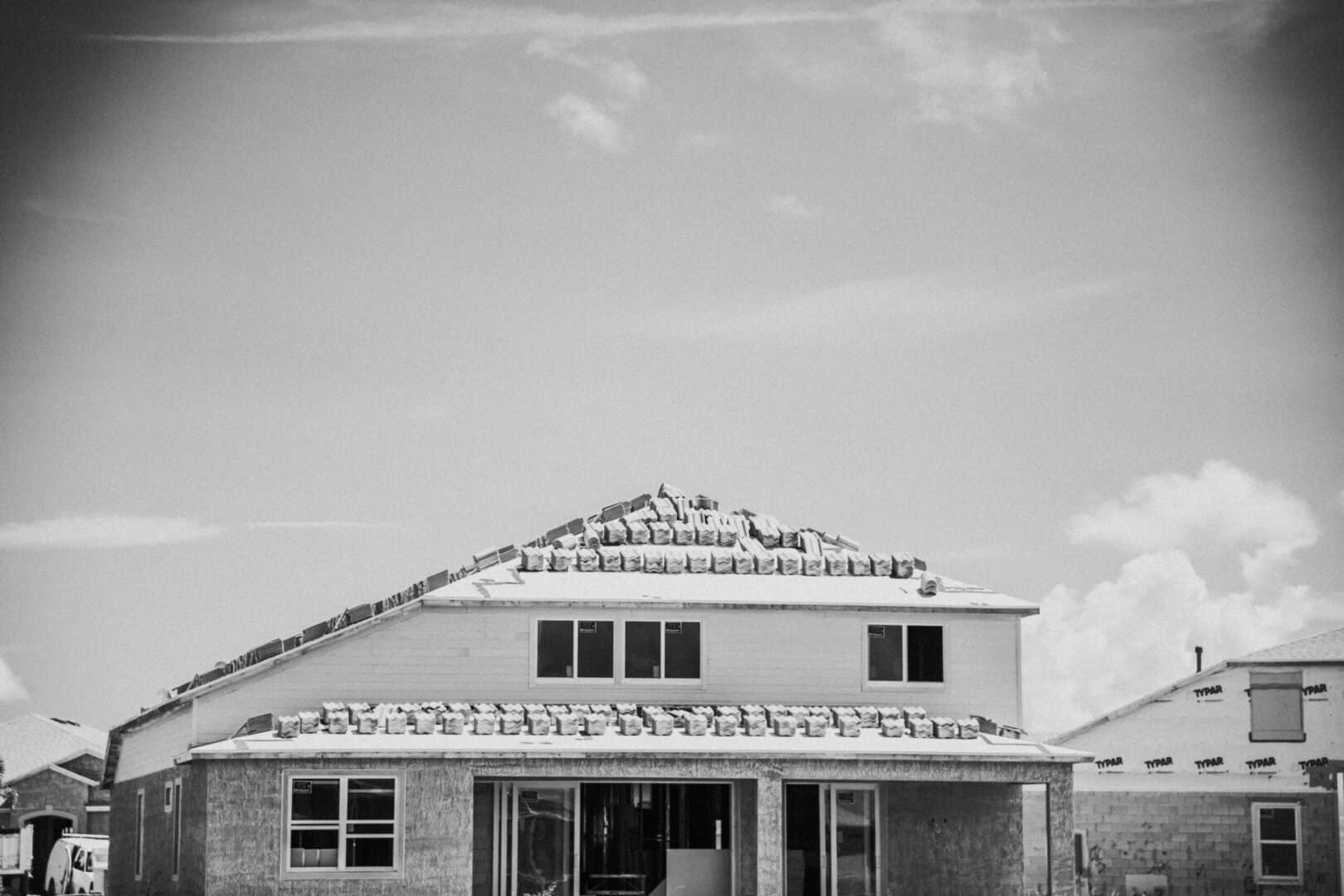 Black and white images of Roof Materials spread out of house's roof for a roof replacement in Denver