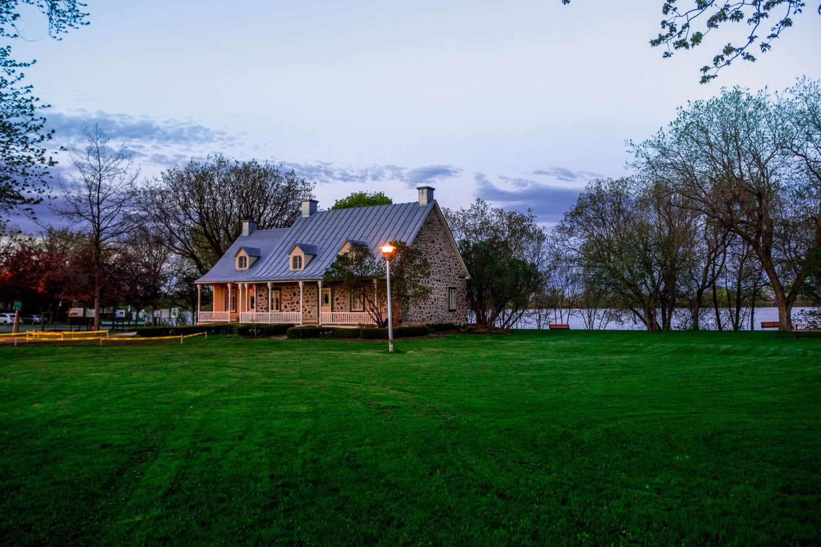 House with large green lawn and a standing seam metal roof