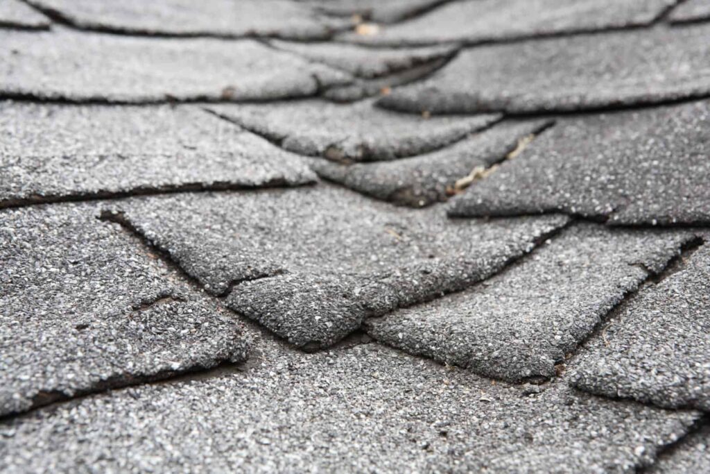 Warped roof shingles on a Charlotte, NC home that needs replacing by Charlotte roofing company