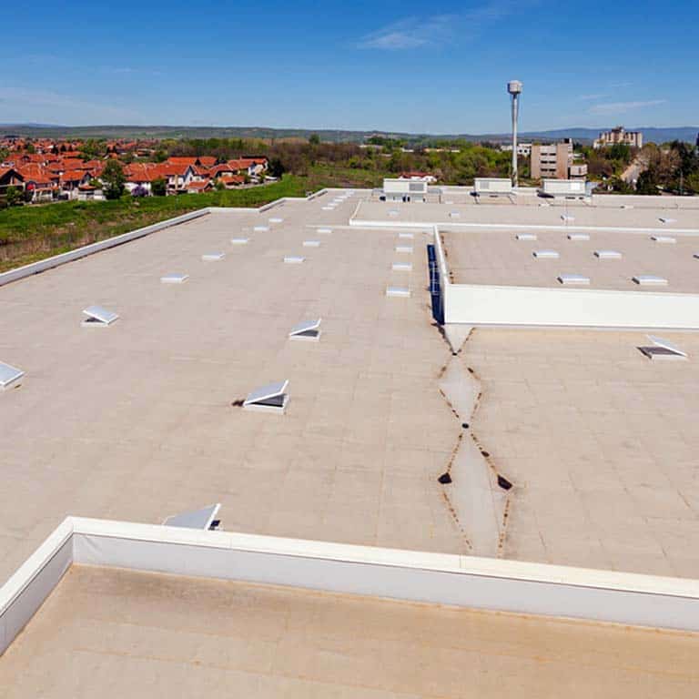 A commercial roof in Charlotte with a blue sky behind it.