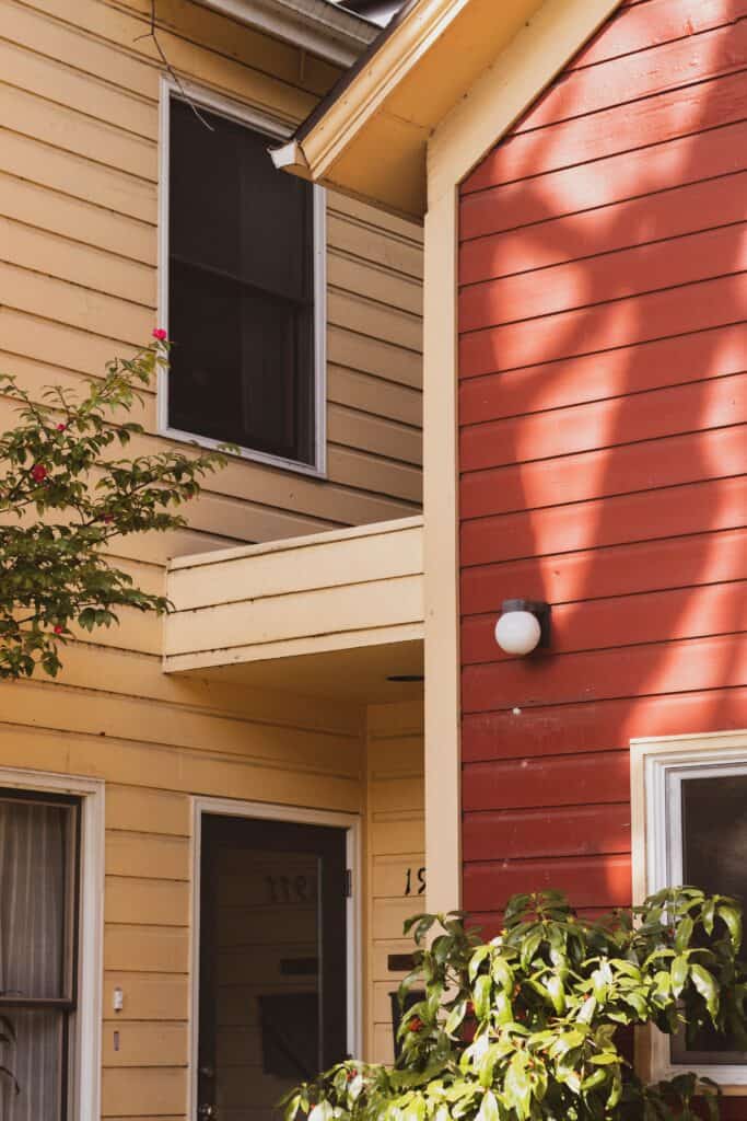 Close up of siding on house, red and cream colored siding installed by charlotte roofing contractor