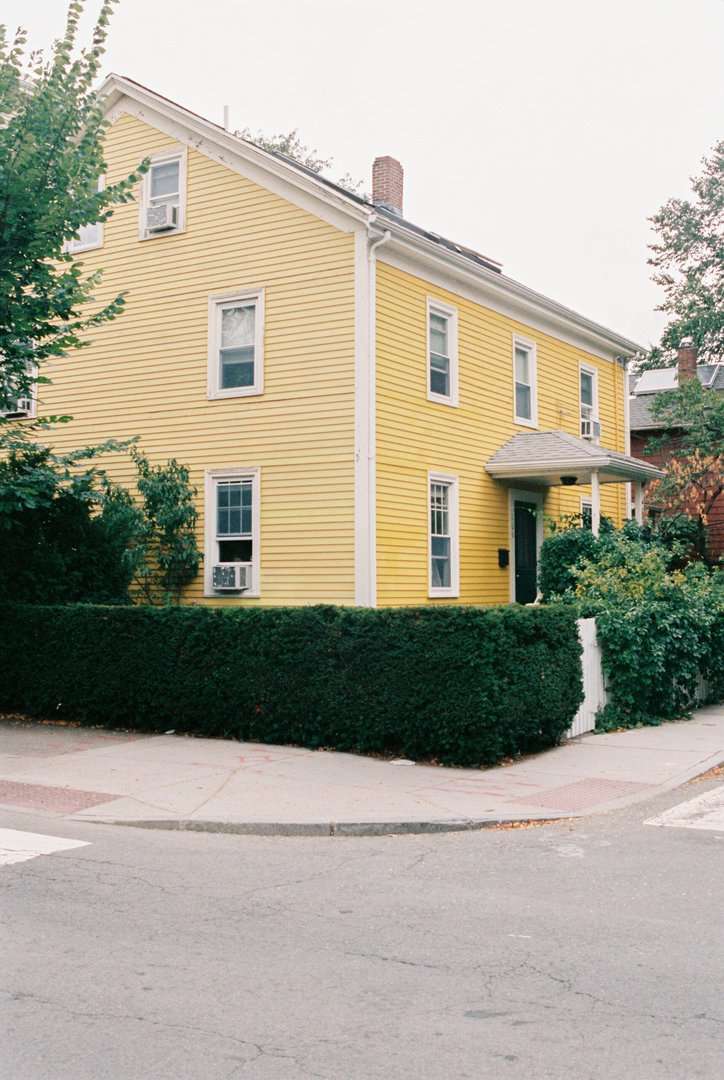 Yellow house on corner taken by Charlotte roofing company