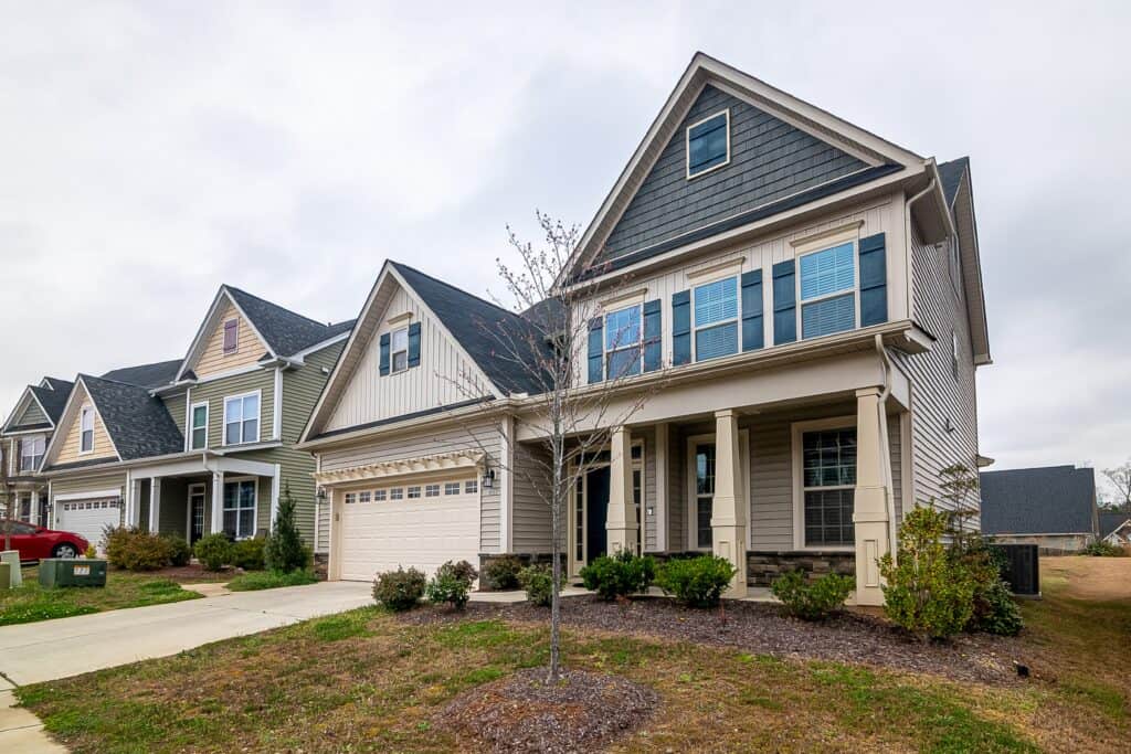 Front of house with gray and cream siding installed by charlotte roofing contractor