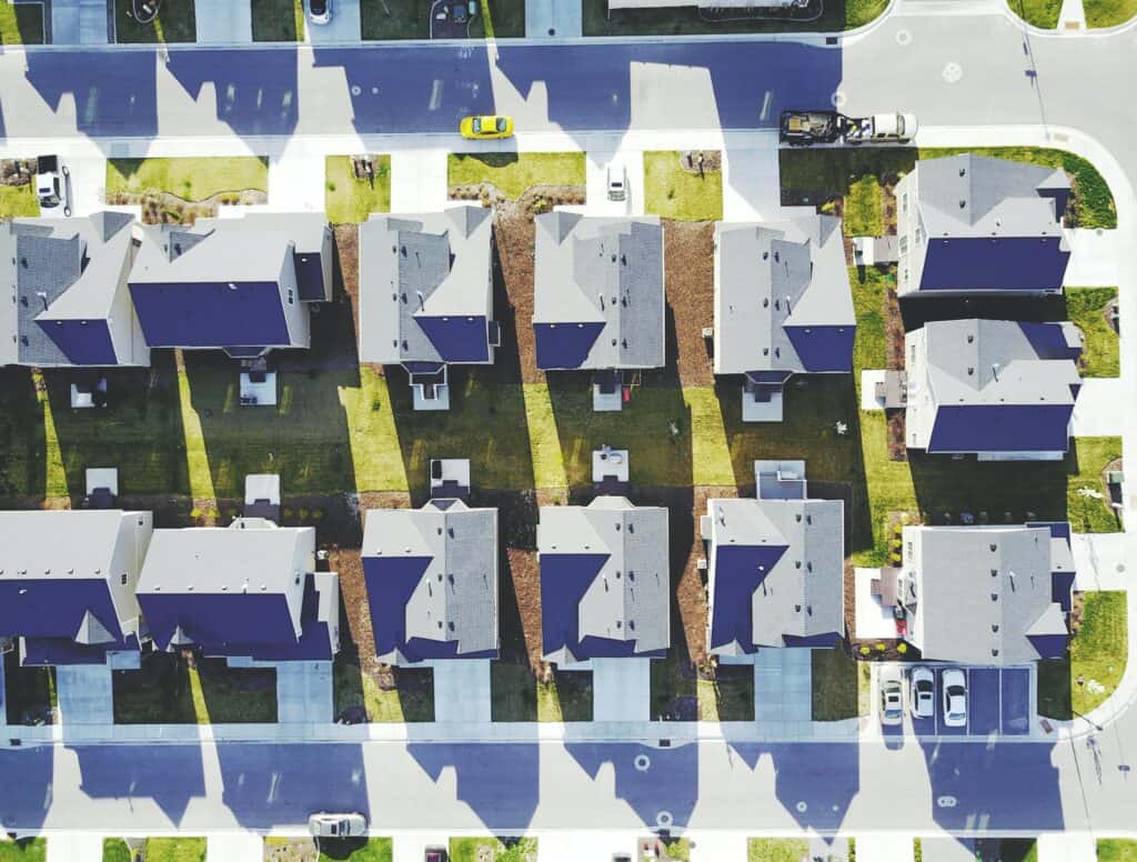An aerial view of houses in a Charlotte neighborhood with asphalt shingle roofs.