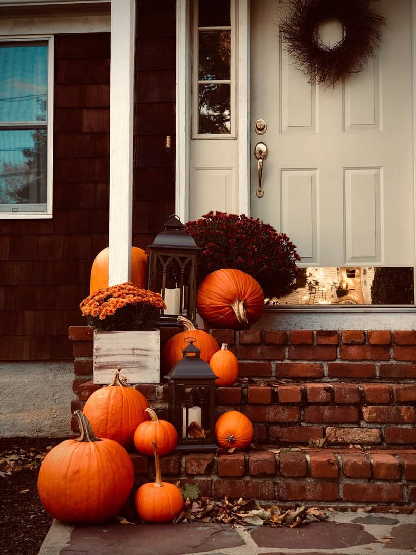 Porch decorated for fall after exterior makeover with roof installation by charlotte roofing contractor