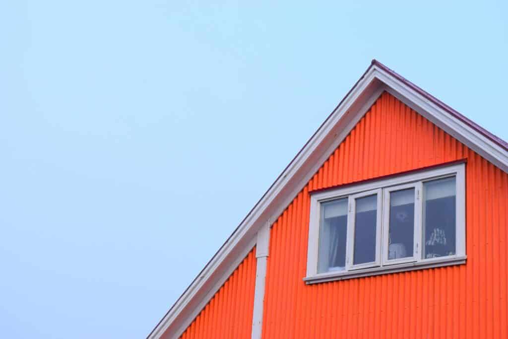 An orange home in Minneapolis that recently had a window installation.