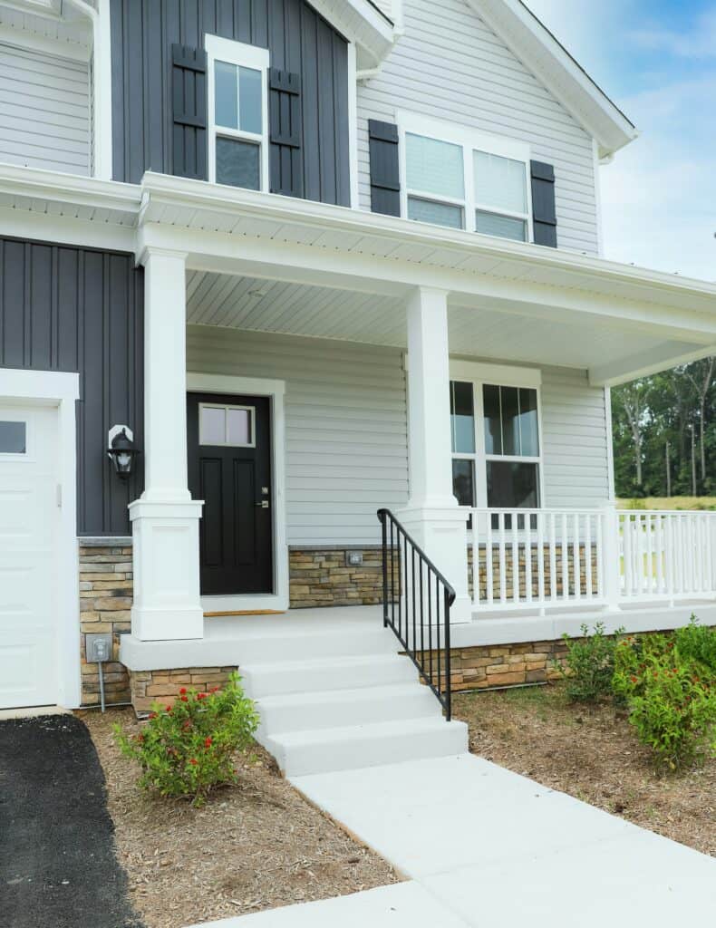 A Charlotte home with white and dark grey vinyl siding.