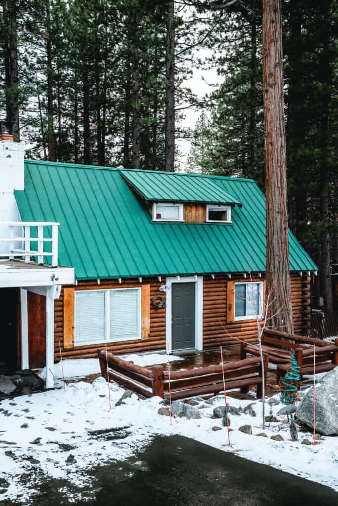 A log cabin in St. Paul with green metal roofing.